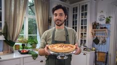 a man holding a pie in his hands