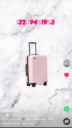 a pink suitcase sitting on top of a white marble floor next to a red heart