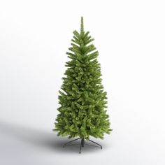 a small green christmas tree sitting on top of a metal stand