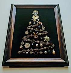 a framed christmas tree made out of jewelry