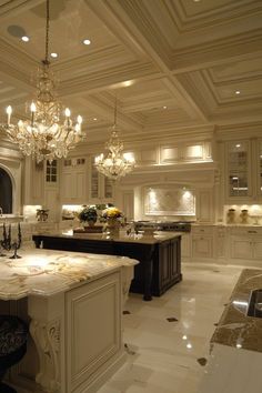 an elegant kitchen with chandelier and marble counter tops