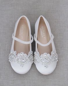 "Classic satin ballet flats with added oversized romantic lace embellished applique and create a vintage look. Great for comfort and perfect for flower girls or stylish princess. *If your sizes are not available, please message us and we will be glad to help with your sizing* DETAILS: COLORS AVAILABLE: White, Ivory, Champagne UPPER: Synthetic upper and lining MATERIALS: Mandmade outsole ORIGIN: Imported STYLE NAME: FREEMAN Not sure of which size to purchase? Shoes measurements are as follow: (Pl Communion Shoes, Birthday Shoes, Satin Ballet Flats, Rhinestone Appliques, Romantic Lace, Mary Jane Flats, Flower Girls, Formal Shoes, White Satin