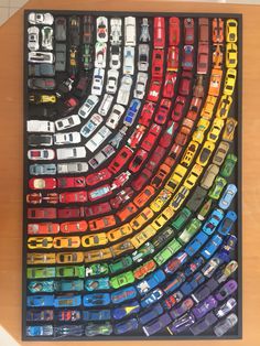 there are many cars in the rainbow colored car magnets on this table and it looks like they could be made out of legos