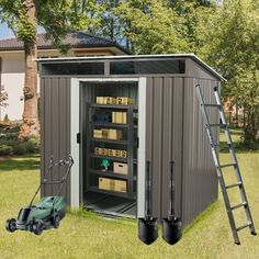 an outdoor storage shed with its door open and tools in the grass next to it