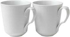 two white coffee mugs sitting next to each other