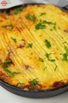 an omelet with cheese and parsley in a pan