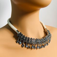 Women's Indian Dark Grey Necklace - Handcrafted Traditional Kundan Ethnic Jewellery Add a touch of tradition and sophistication to your collection with this Women's Indian Dark Grey Necklace. Handcrafted with meticulous care, this necklace features a rich dark grey tone, enhanced by hand-tampered Kundan work, reflecting the elegance and beauty of Indian ethnic craftsmanship. The intricate detailing of the Kundan stones combined with the bold statement design makes this necklace a stunning choice White Bohemian Necklaces With Latkans, Bohemian White Necklaces With Latkans, Bohemian White Necklaces With Silver Beads, White Bohemian Jewelry With Latkans, Bohemian White Jewelry With Latkans, Grey Necklace, Jewellery Traditional, Kundan Work, Gray Necklace