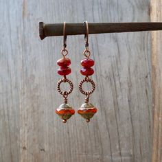 Perfect for fall! The beads on these earrings are all Czech glass beads. They are a mix of oranges. They are available with antique brass or copper findings. They are also available with titanium ear wire. The bottom bead is 10mm, Saturn shaped bead with a Picasso finish. The top beads are a terra cotta and clear dark red (almost Burgundy) bead they are 4x7mm. This listing is for the earrings shown in the first few photos. NOTE: If you want titanium, but prefer copper on the rest of the earrings Nickel Free Czech Glass Dangle Earrings, Nickel-free Czech Glass Drop Earrings, Nickel-free Czech Glass Earrings For Jewelry Making, Czech Glass Drop Earrings For Gifts, Bohemian Glass Drop Earrings, Adjustable Czech Glass Earrings With Ear Wire, Czech Glass Dangling Beads Drop Earrings, Czech Glass Drop Earrings With Dangling Beads, Glass Dangle Earrings For Pierced Ears