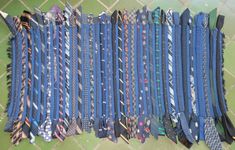 a bunch of ties that are laying on the ground next to each other in rows