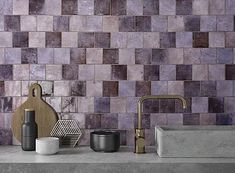 a kitchen counter top with various items on it, including a sink and faucet