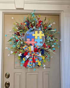 a wreath with puzzle pieces hanging on the front door to welcome you into the office