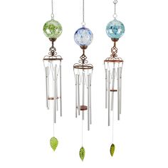 three wind chimes hanging from chains with green leaves and blue glass balls on them