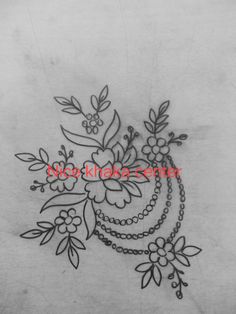 the back side of a woman's stomach with flowers and chains on it