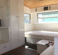 the inside of a tiny house with white walls and wood flooring is shown in this image