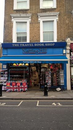 the travel book shop is on the side of the road in front of a building