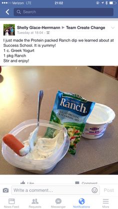 a plastic container filled with yogurt and a carrot on top of a table