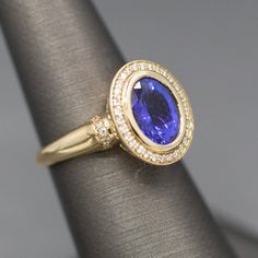 Handcrafted Bold Bezel Set Tanzanite and Diamond Ring in 14k Yellow Go – The Jeweled Crescent Tanzanite Ring With Bezel Setting For Anniversary, Bezel Set Tanzanite Jewelry For Anniversary, Luxury Round Sapphire Ring With Bezel Setting, Formal Tanzanite Ring With Bezel Setting, Anniversary Tanzanite Jewelry With Bezel Setting, Luxury Blue Diamond Ring With Bezel Setting, Bezel Set Tanzanite Ring, Tanzanite Ring With Bezel Setting, Classic Tanzanite Rings With Bezel Setting