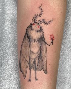 a woman's leg with a tattoo on it and an insect holding a dandelion