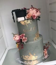 a three tiered cake with flowers on top