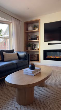 a living room with two couches and a coffee table in front of a fireplace