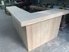 an unfinished counter in a garage with tools