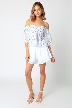 Final Sale-Get it before it's gone! Stroll along the Amalfi coast in the picture-perfect Positano White and Blue Floral Babydoll Top! The white and blue floral print fabric forms a cold shoulder neckline, ruched bust, and attached puff sleeve with crochet lace trim. Style with white shorts and sandals for a fun vacay look! DETAILS & CARE 100% Rayon. Machine wash cold. Imported. White Off-shoulder Blouse For Spring, Spring Off-shoulder Beach Tops, Spring Off-shoulder Tops For The Beach, Spring Off-shoulder Tops For Beach, Fitted Off-shoulder Top For Beach Season, Breezy Flowy White Top, Blue Cold Shoulder Tops For Spring, Breezy White Blouse For Spring, White Breezy Blouse For Spring