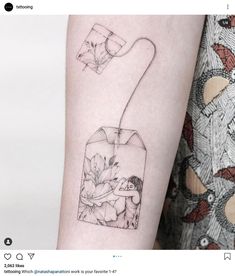 a woman's arm with a flower in a vase tattoo on the left forearm