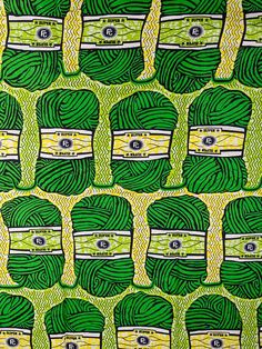 an image of green and yellow fabric with many different designs on the front, one is made out of yarn