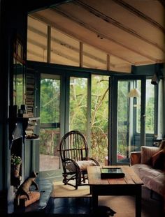 a living room filled with furniture and lots of windows