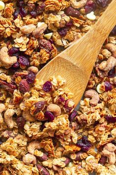 healthy granola with nuts and cranberries in a wooden spoon