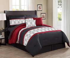 a bed with red and black comforters in a room