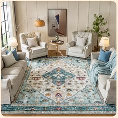 a living room with couches, chairs and a rug on the floor in front of a window