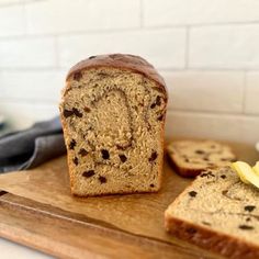 a loaf of chocolate chip banana bread on a cutting board with slices cut off the side