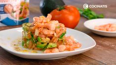 a white plate topped with shrimp and broccoli next to a carton of yogurt