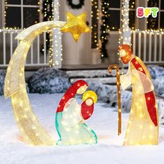 a nativity scene in front of a house decorated for christmas