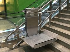 an escalator on the ground next to some stairs