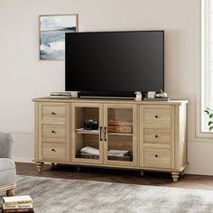 a flat screen tv sitting on top of a wooden cabinet