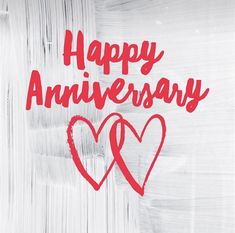 the words happy anniversary are drawn in red ink on white paper with two heart shapes