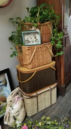 three wicker baskets stacked on top of each other with plants growing out of them