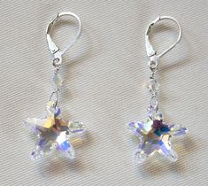 Handcrafted Clear Swarovski starfish earrings are a great sister birthday gift or 50th birthday gift for best friend! Perfect beach wedding jewelry! These cute and sparkly earrings have precision faceted stones which create a stunning elegance that is truly unforgettable. Pictures don't do justice to them! Crystal AB Swarovski crystal starfish are wire wrapped to crystal ab 4mm crystals and sterling silver lever back ear wires. Earring hangs approximately 1' from the ear wire. Comes with Starfis Sterling Silver Star Earrings For Wedding, Star-shaped Sparkling Earrings For Anniversary, Sparkling Star-shaped Earrings For Anniversary, Ocean-inspired Star Earrings For The Beach, Wedding Star-shaped Sterling Silver Earrings, Birthday For Friend, Nickel-free Starfish Earrings As Gift, Summer Ocean-inspired Starfish Earrings, Starfish-shaped Nickel-free Earrings For Gifts