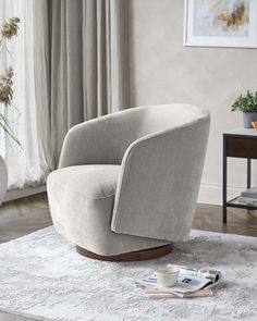 a chair sitting on top of a white rug next to a vase and potted plant