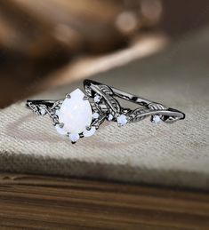 a white opal ring sitting on top of a book