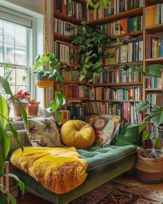 a living room filled with lots of books and plants on top of a green couch