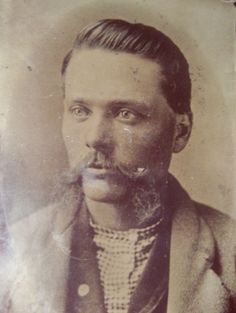 an old black and white photo of a man with a moustache on his face