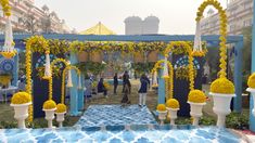 an outdoor ceremony with yellow and blue decorations