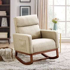 a living room with a rocking chair and bookshelf