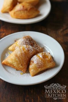 two plates with pastries on them sitting on a table