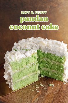 there is a green cake with white frosting on the top and one slice missing