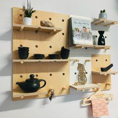 the shelves are made out of plywood and have wooden pegs to hold items