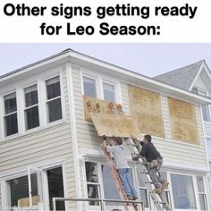 two men are painting the side of a house